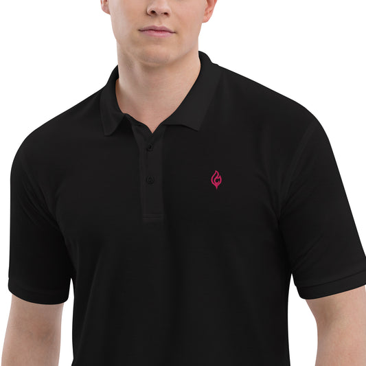 Close-up waist-to-jaw view of male model wearing Ciao Cult Men’s Signature Flame Polo in black with flamingo-pink flame emblem.