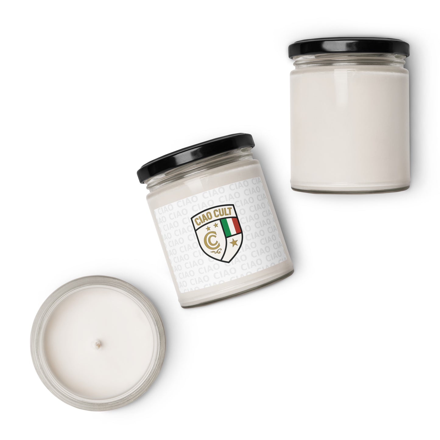Two white soy candles with black lids, one upright and one tilted, featuring a white label with a gold and red crest emblem. - Ciao Cult - Apple Harvest