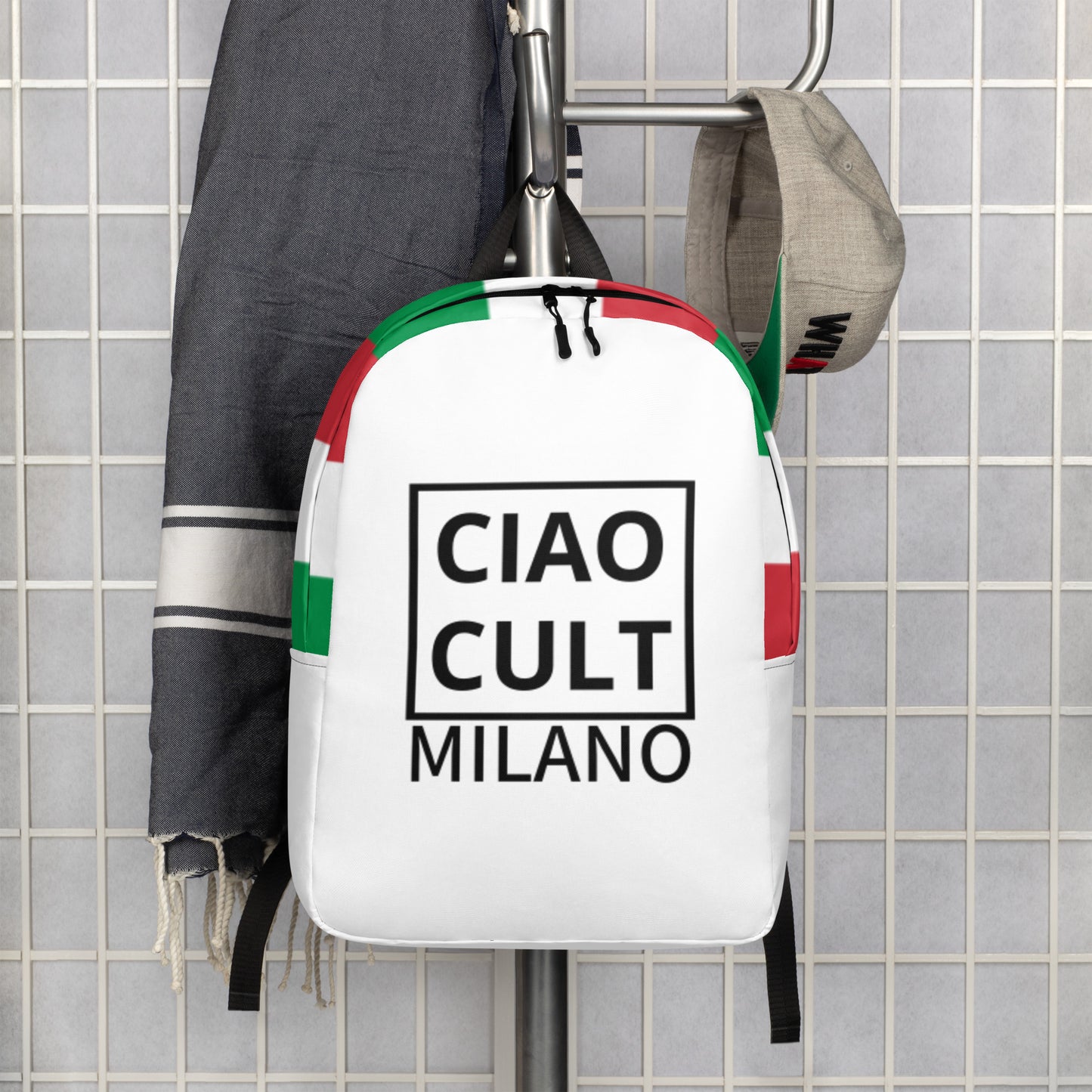 White CIAO CULT MILANO backpack with black logo print and green and red accents, hanging on a grid wall. - Ciao Cult - Default Title