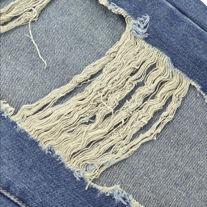 Close-up of Ciao Cult Women’s High-Waist Ripped Straight-Leg Jeans ripped knee section showing distressed and frayed detail.