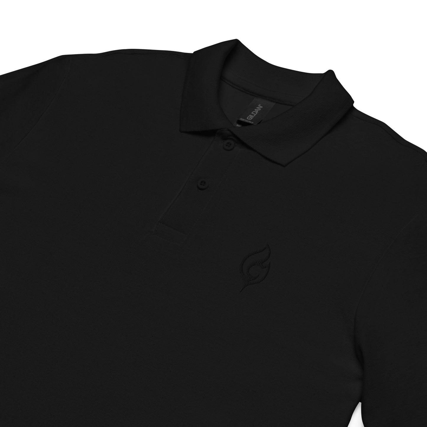 Flat lay close-up of Ciao Cult Tonal Black-on-Black Signature Flame Polo showing tonal embroidered flame emblem on chest.