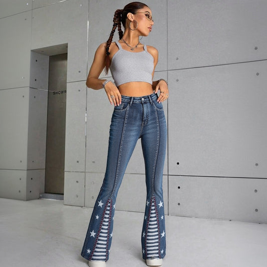 Woman wearing blue jeans with star and stripe pattern in a modern indoor setting.