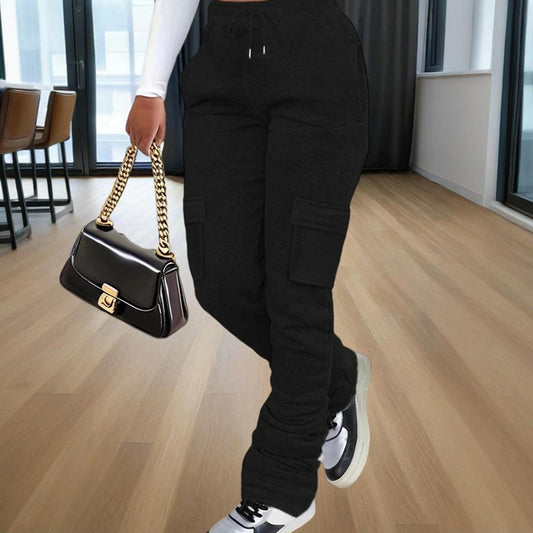 Model waist down wearing Ciao Cult Women’s Straight-Leg Pants in black, front walking pose holding black purse.