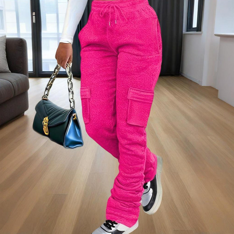 Model waist down wearing Ciao Cult Women’s Straight-Leg Pants in rose red, front walking pose holding black purse.