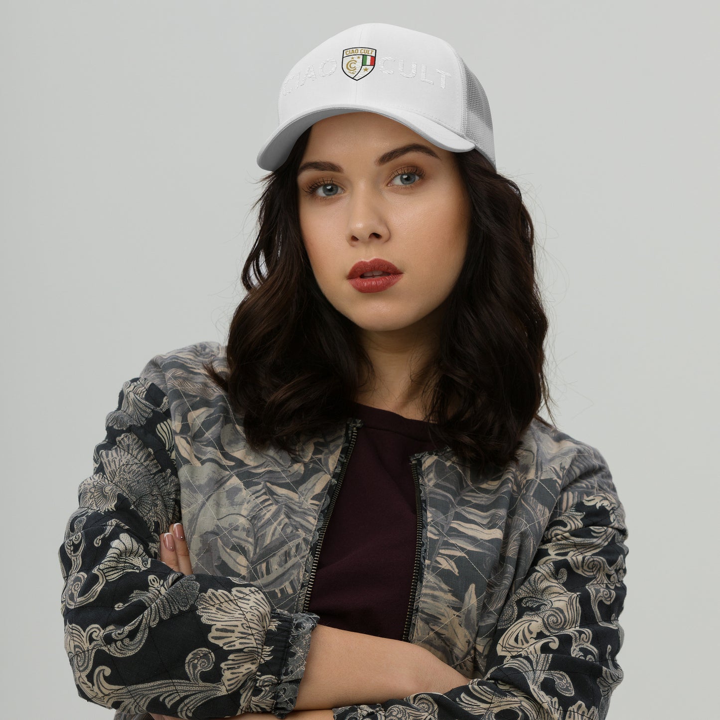 White trucker cap with embroidered colorful crest logo and mesh back on female model. - Ciao Cult - Default Title