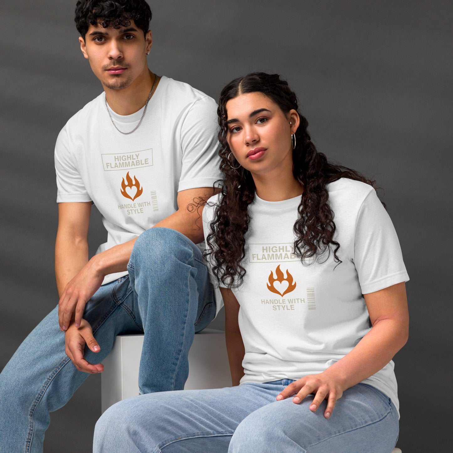 White unisex t-shirts with brown "Highly Flammable" text and flame barcode graphic, styled with light blue jeans. - Ciao Cult - Black / XS